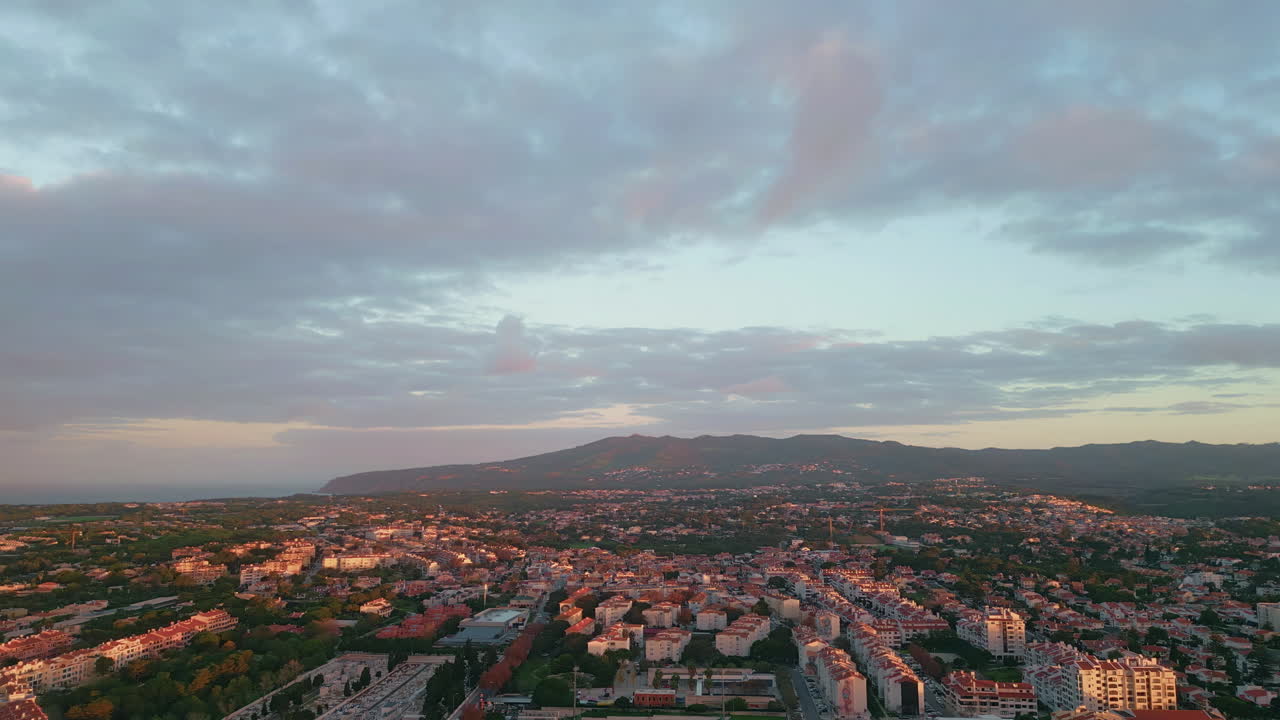 Aerial city landscape dusk with scenic cloudy skyline. Urban area with buildings