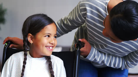 Mother-interacting-with-girl-in-wheel-chair