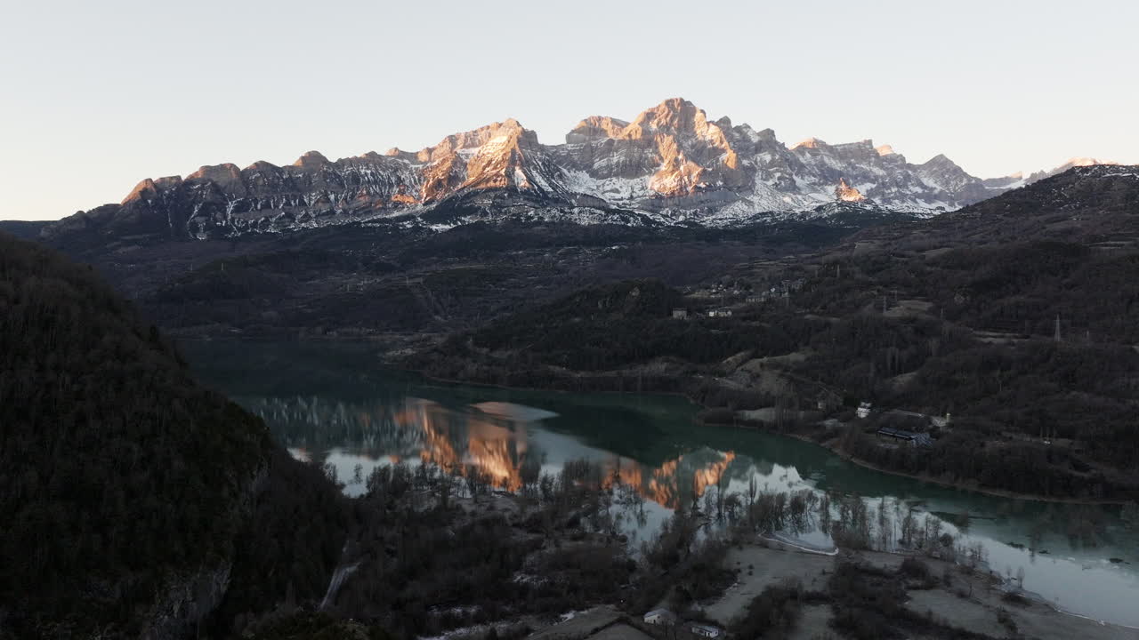Sunrise over Snowy Mountain Range and Lake