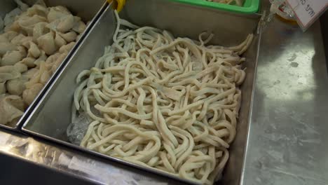 seafood fish cake noodle at street food market booth court for sale documentary