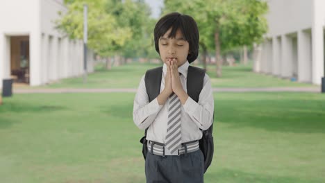 indian school boy praying to god