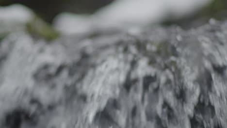 clean water flowing over the edge of a waterfall close up