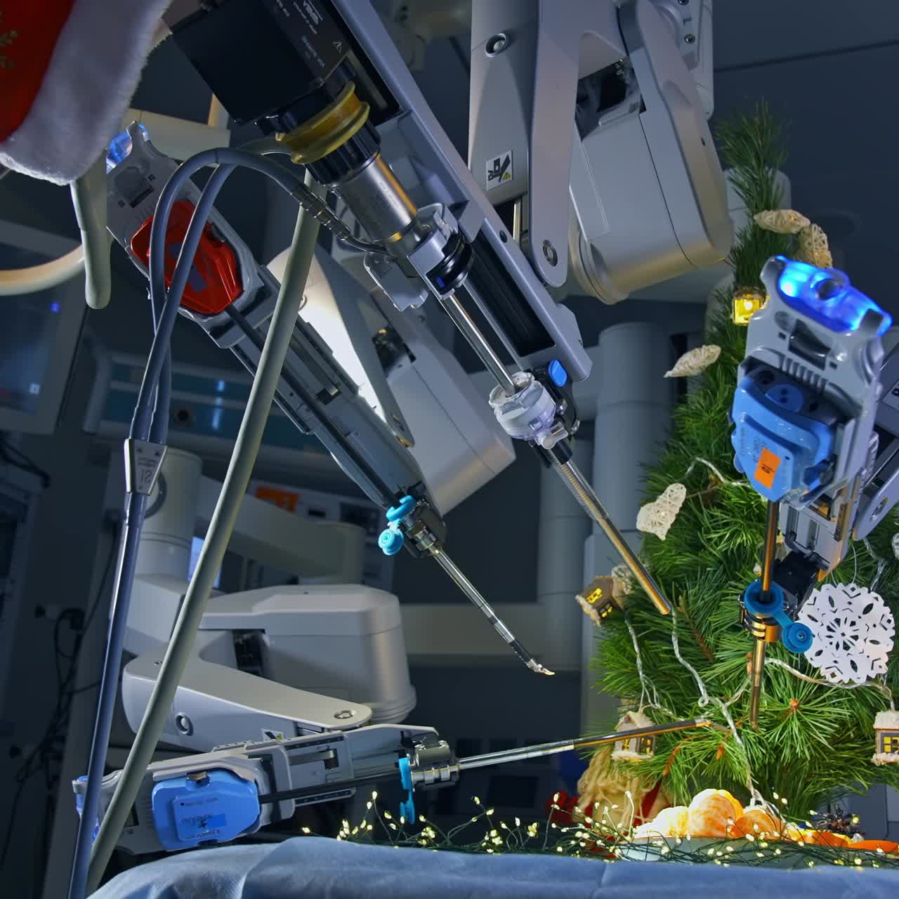 Fantastic work of innovative surgical equipment to decorate New Year tree. Da Vinci robotic arms moving and decorating Christmas tree on the operating table. View from below