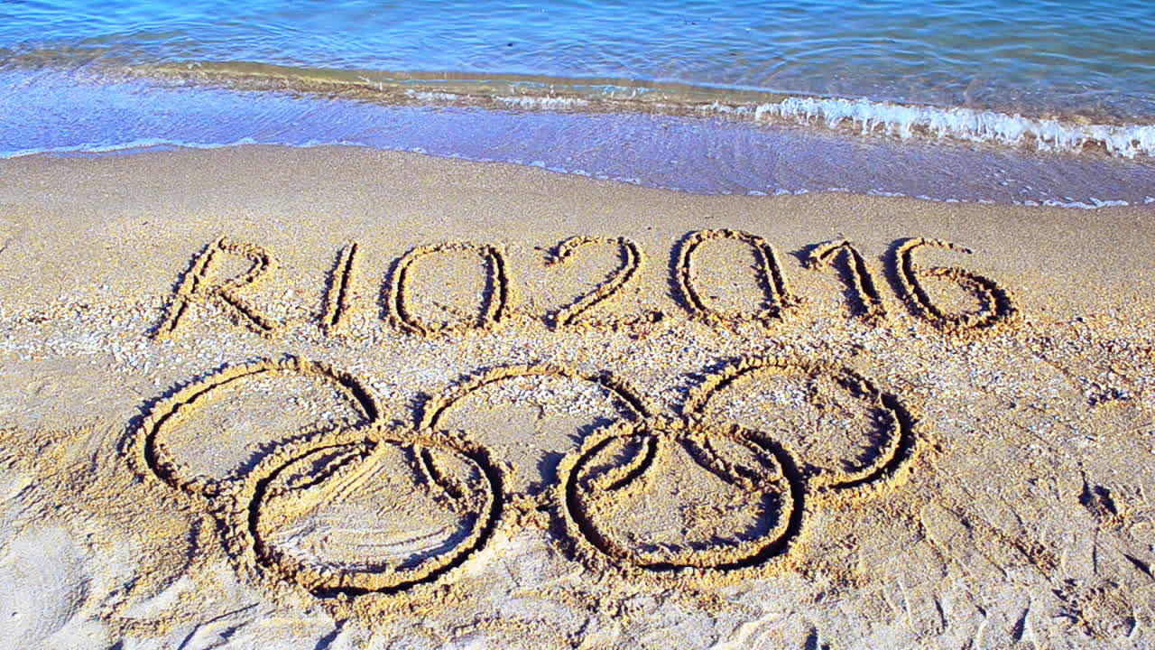Rio 2016 an inscription on sand, the beach. Symbol Olympic game on sand, the beach
