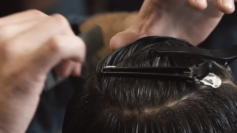close-up of a barber styling hair