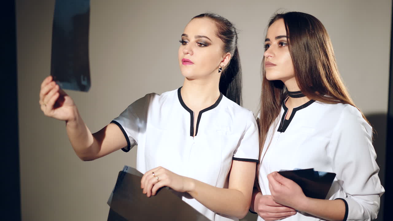 Radiology department. Female doctors examining x-ray in the medical office