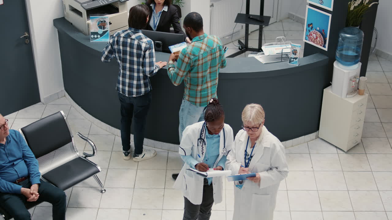 Hospital reception area with medical staff and patients