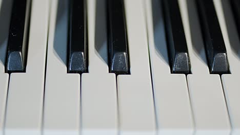 piano keys in a close up, fast tracking shot, from left to right