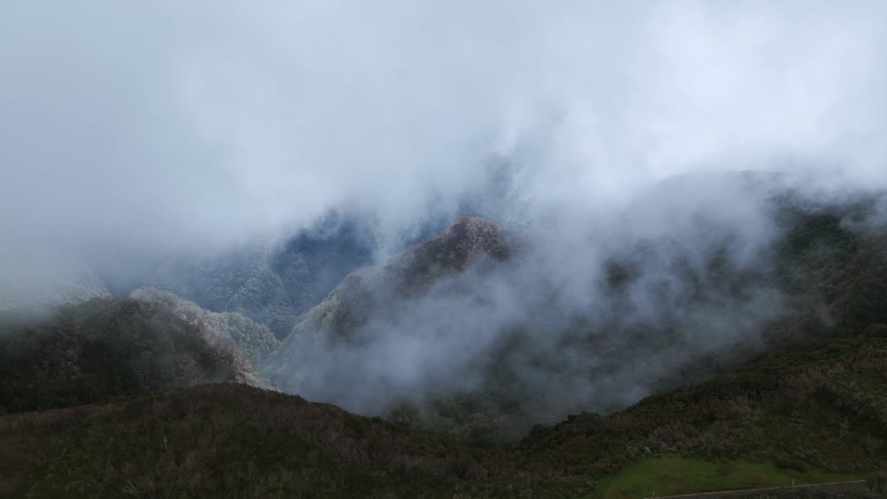 Fog covering mountain slopes in Madeira, Portugal, creating a mysterious atmosphere