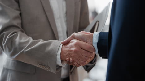 close-up-business-people-shaking-hands--corporate-partnership-deal-welcoming-opportunity-for-cooperation-in-office