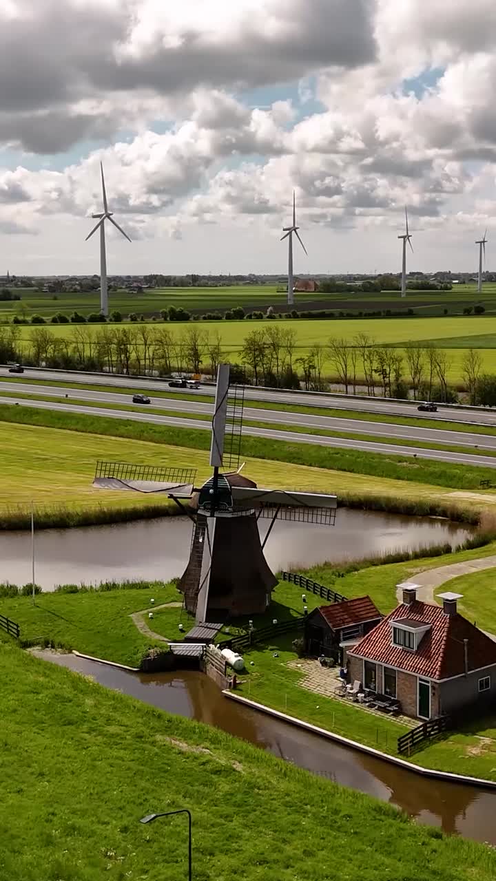 Dutch Windmill and Canal Landscape with Highway and Wind Turbine