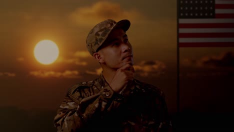 close up of asian man soldier thinking and looking around then raising his index finger while standing with flag of the united states, sunset time