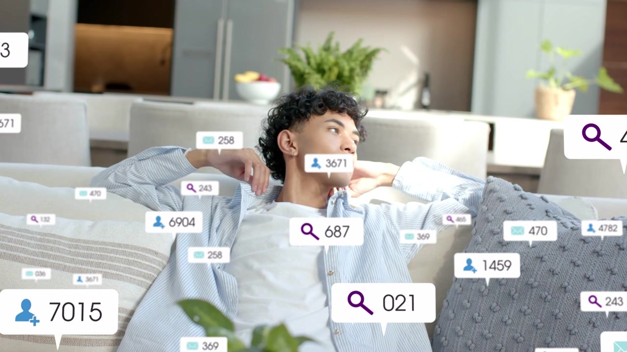 Vertical video: Reacting man in striped shirt lounging at home turning head as UI badges multiply