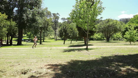 a woman jogs down a path as they camera fades to another shot of her running