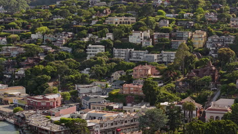 sausalito, california usa. drone shot of upscale hillside homes on sunny day, buildings and coastal traffic
