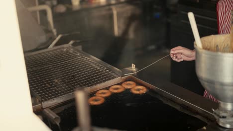 donuts frying in oil, slow motion