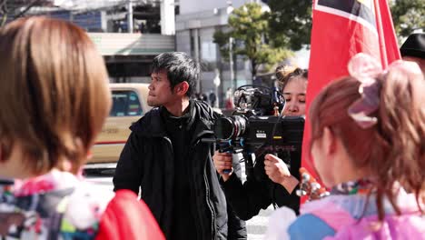 cameraman filming subjects in urban setting