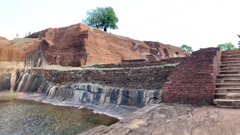 scenic view of the ancient sigiriya lion rock's steps and royal swimming pool in sri lanka, capturing historical architecture and natural beauty.