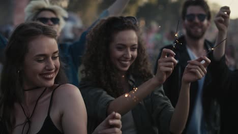 group of caucasian young people dancing on music festival with sparklers