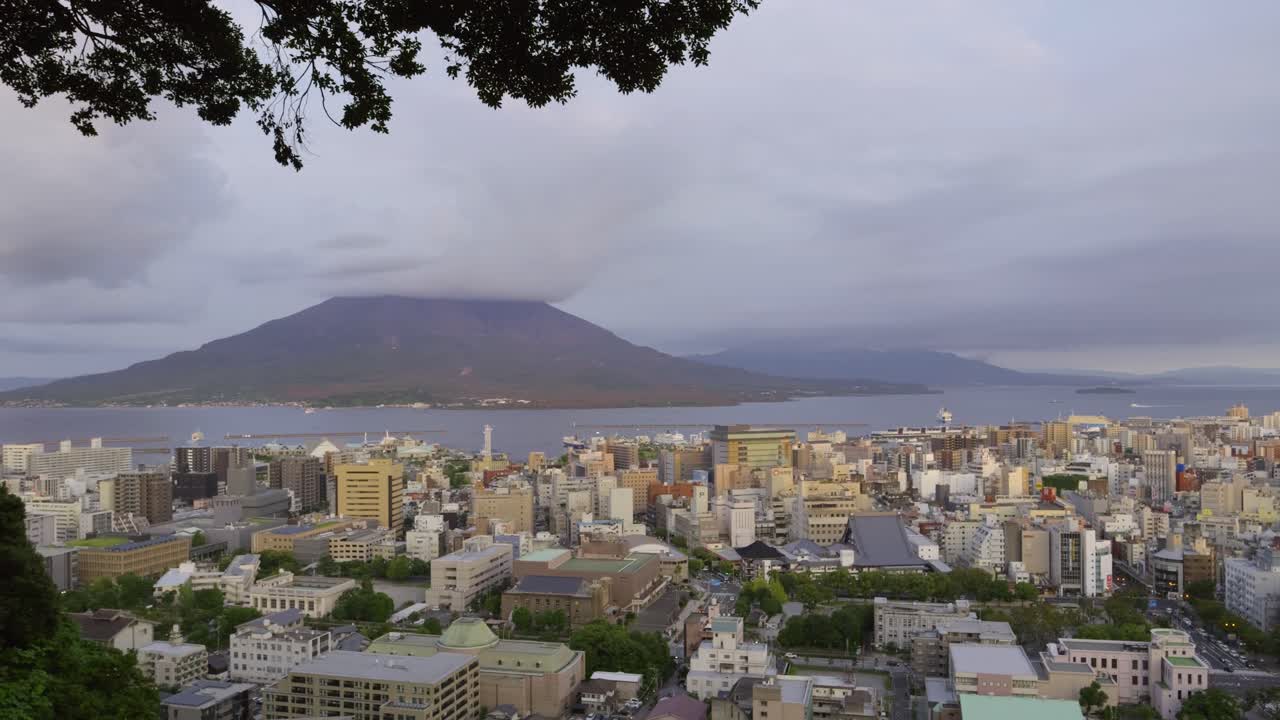 Left panning panorama shot over Kagoshima city with Sakurajima bay in distance