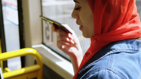 mujer con hijab usando teléfono móvil 4k