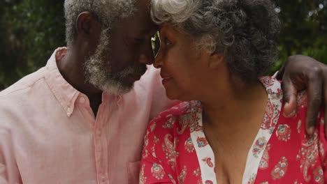 A-senior-African-american-couple-enjoying-a-glass-of-wine-in-social-distancing