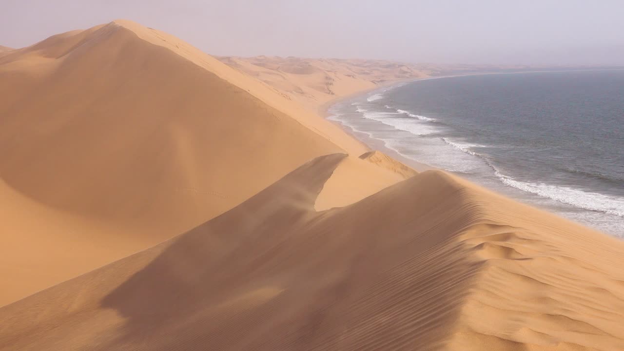 fuertes vientos soplan a través de las increíbles dunas de arena del desierto de namib a lo largo de la costa esquelética de namibia 7