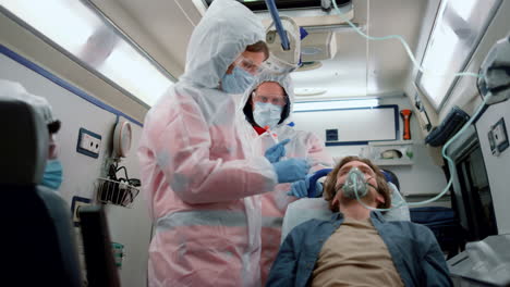 mixed race doctors taking nasophargeal swab of patient for coronavirus sample