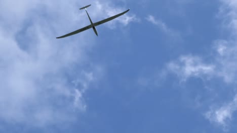 motor plane and glider plane spotted flying in the sky on clear bright day