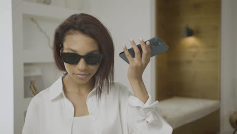 Close-up-view-of-young-blind-woman-talking-on-the-phone