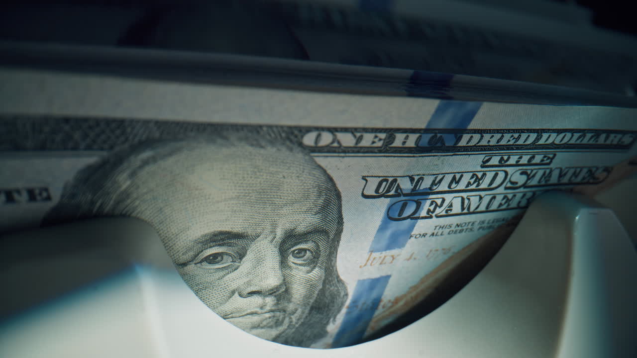 High speed checking bills stacks hundred paper notes in sharp detail indoors