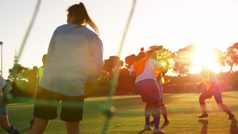 Rear-view-of-diverse-female-soccer-team-training-4k