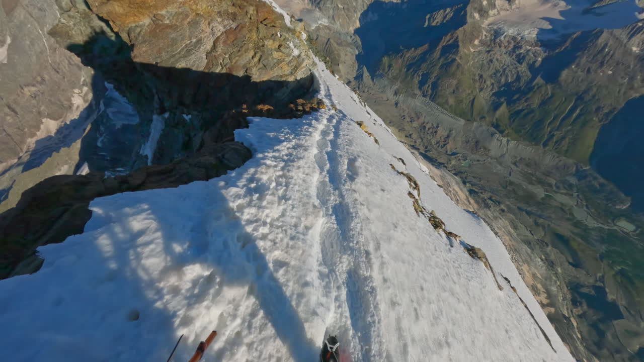 First-person POV of a climber ascending the iconic Matterhorn at sunrise on a crystal-clear bluebird day. Captured on GoPro for an immersive, realistic mountaineering experience above the clouds