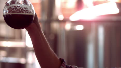 brewery worker checking the product