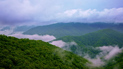 beautiful cinematic pass over fog-bound smoky peaks