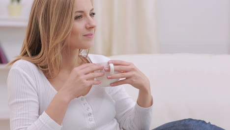 calm woman thinking while drinking a hot drink