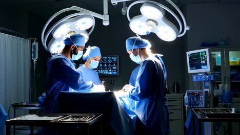 surgeons performing an operation in a brightly lit operating room