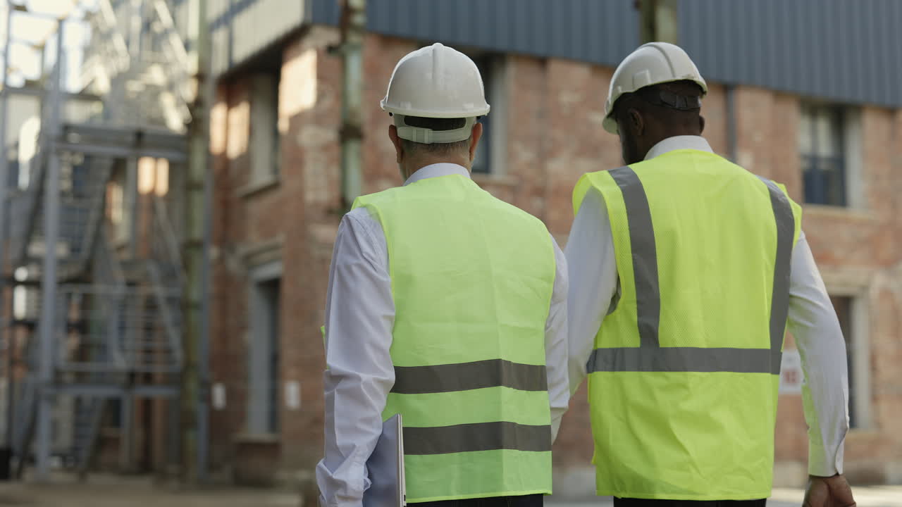 Construction Workers Inspecting Industrial Facility