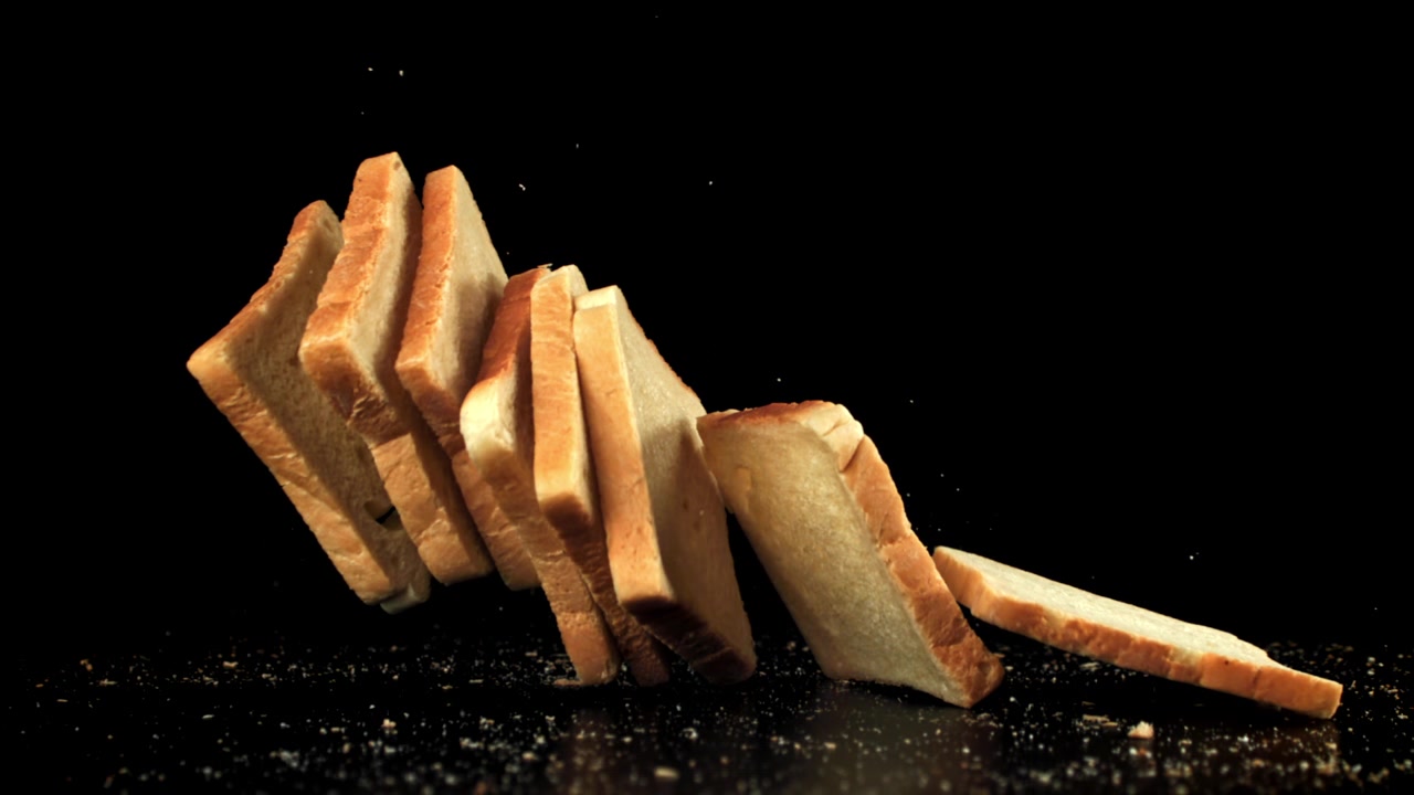 Slow Motion of White Bread Slices Falling and Tipping Over