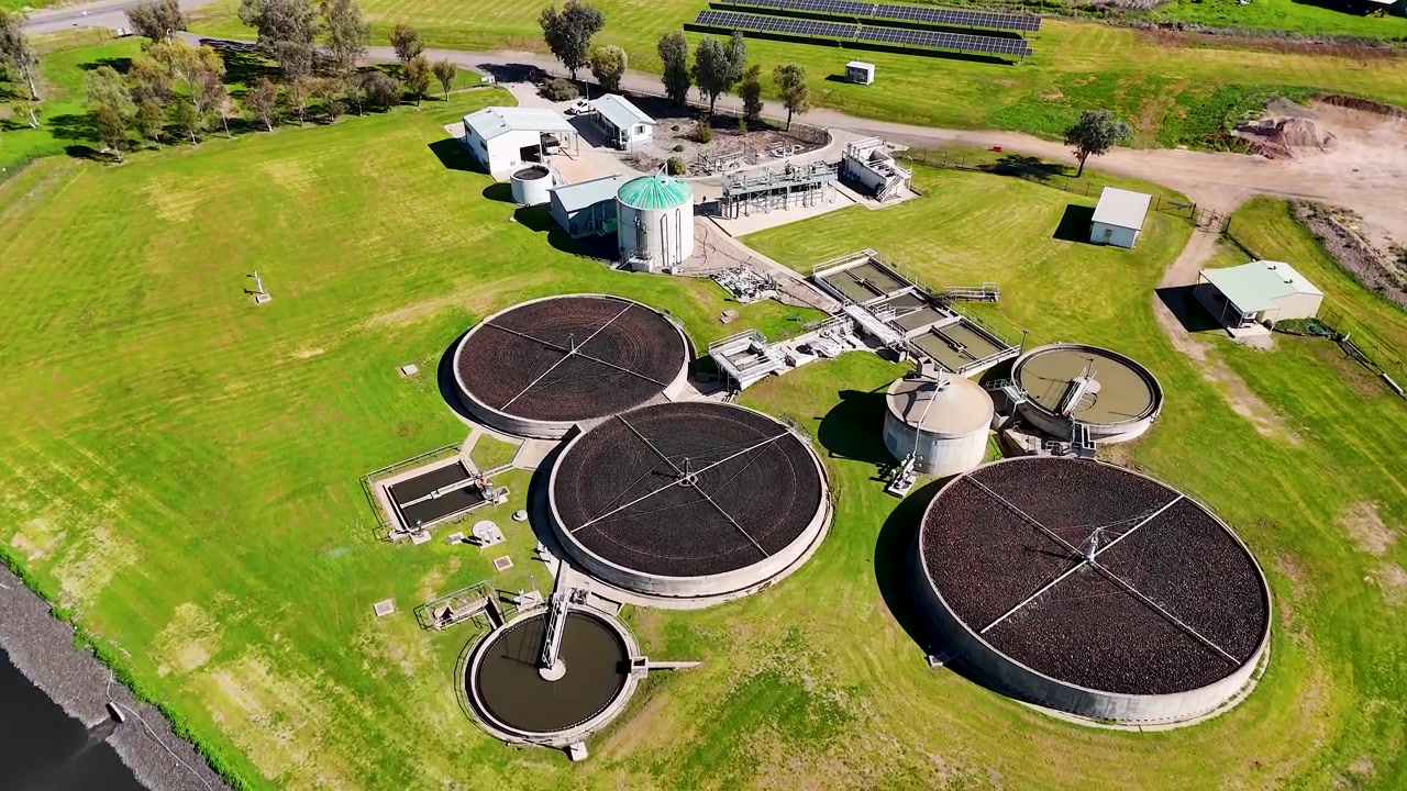 High-angle drone shot of a sewage facility with circular tanks in Gunnedah, New South Wales.