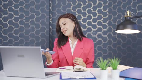 young business woman dancing with phone in hand.