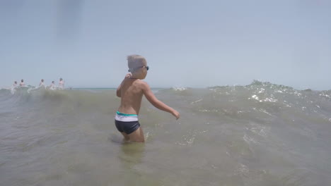 kid bathing in the sea on hot summer day