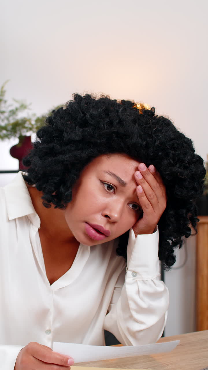 African american businesswoman reads letter frowns sad at tough email job rejection or lost chance
