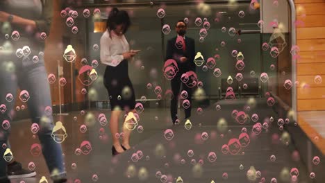 Digital-composite-video-of-humans-wearing-face-mask-icons-against-people-standing-in-a-hallway