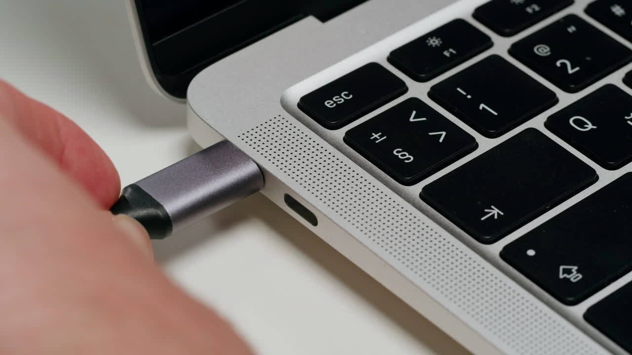 Connecting a USB-C cable to a laptop