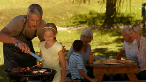 happy family having barbecue in the park