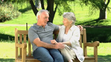 Old-man-and-woman-talking-on-a-bench