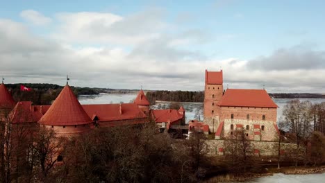 trakai castte lithuania, drone shot of the medieval castle in a frozen lake on a cloudy day