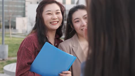 university students talking and having fun together after having classes on the college campus.