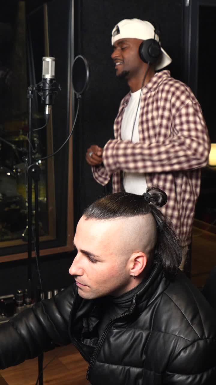 Two Artists Recording Music in a Studio